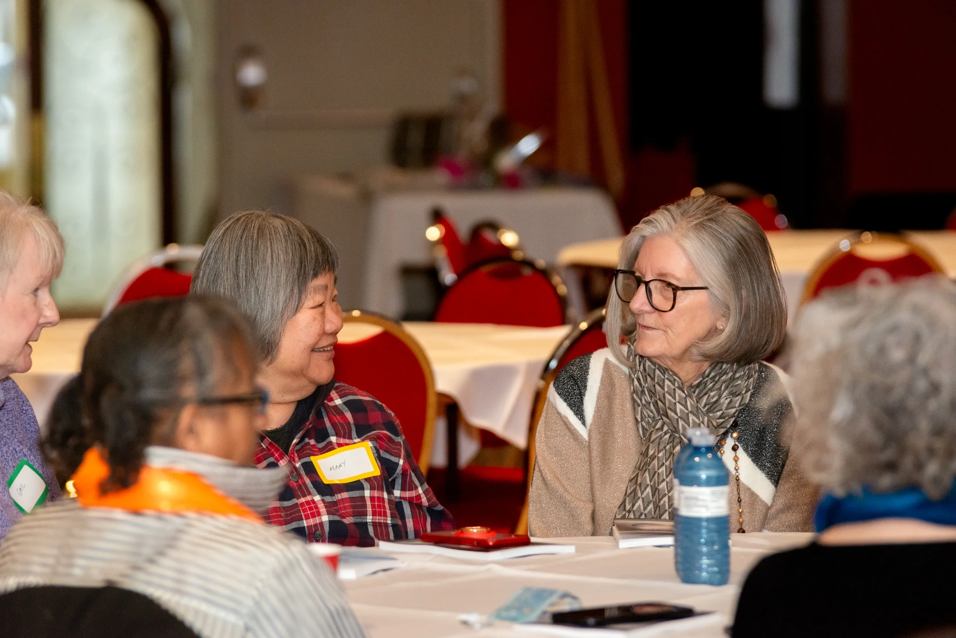 Guests in conversation at a table during the event