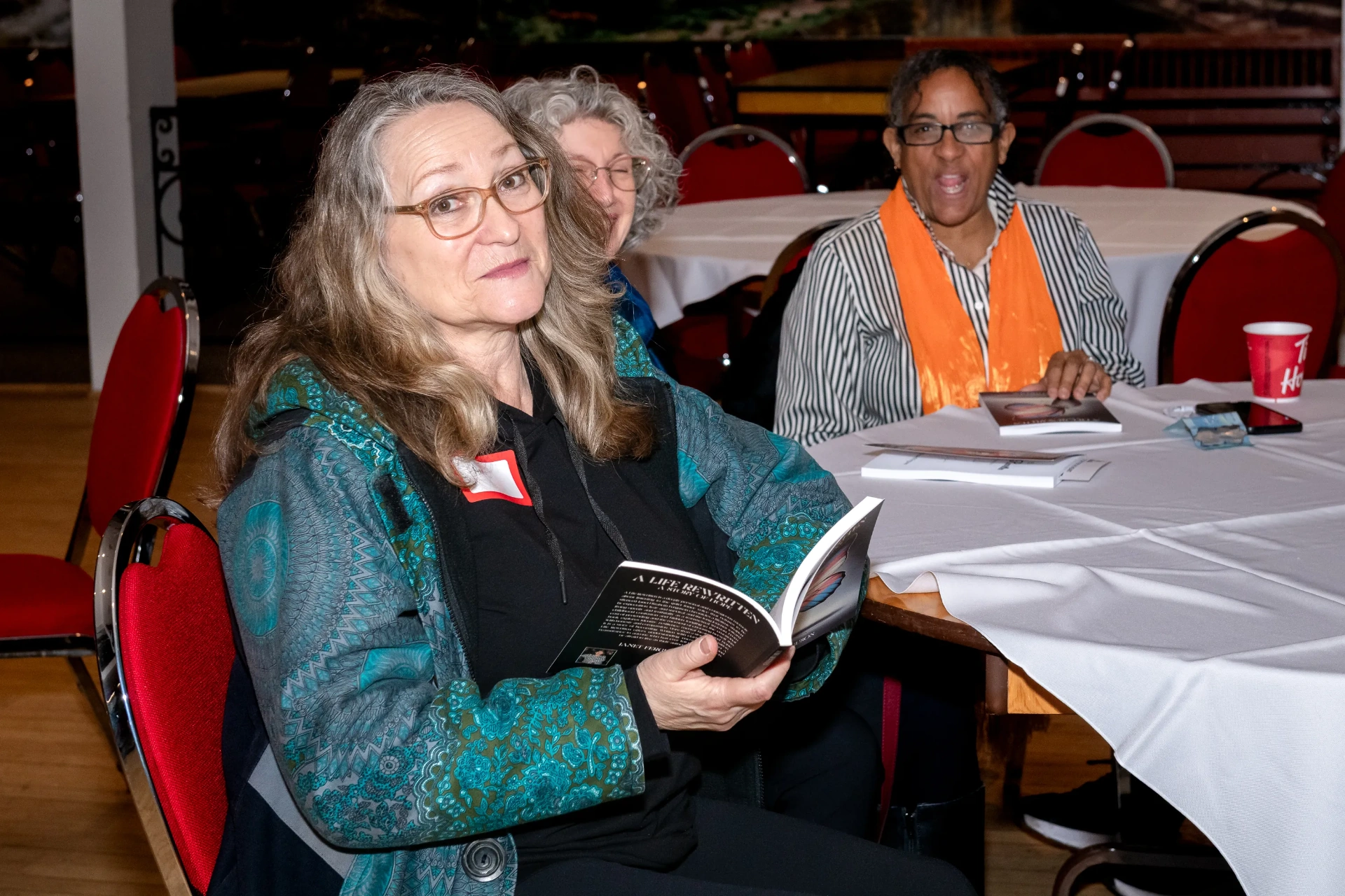 A reader smiles while reading the memoir