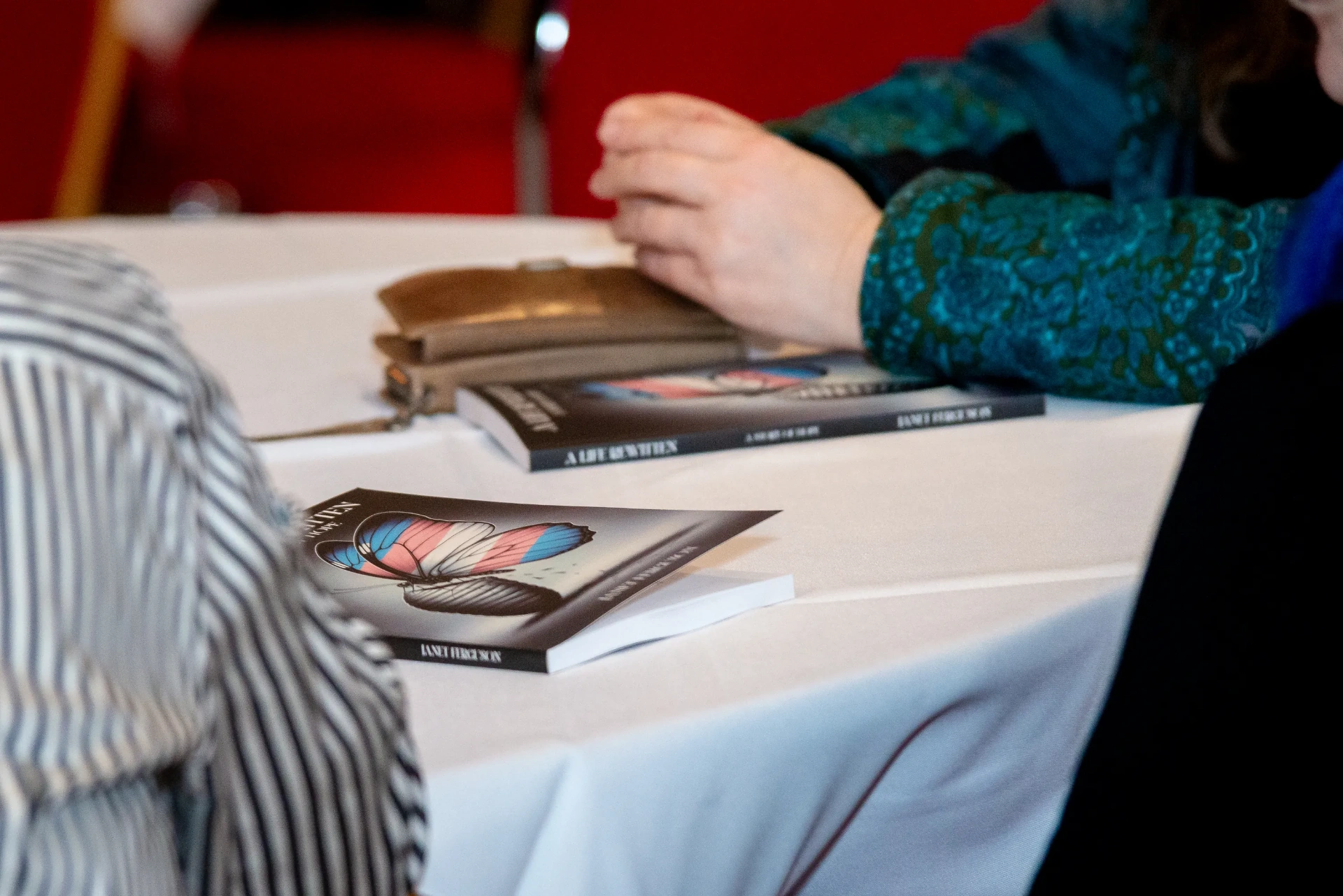 Close-up of two copies of A Life Rewritten on the table