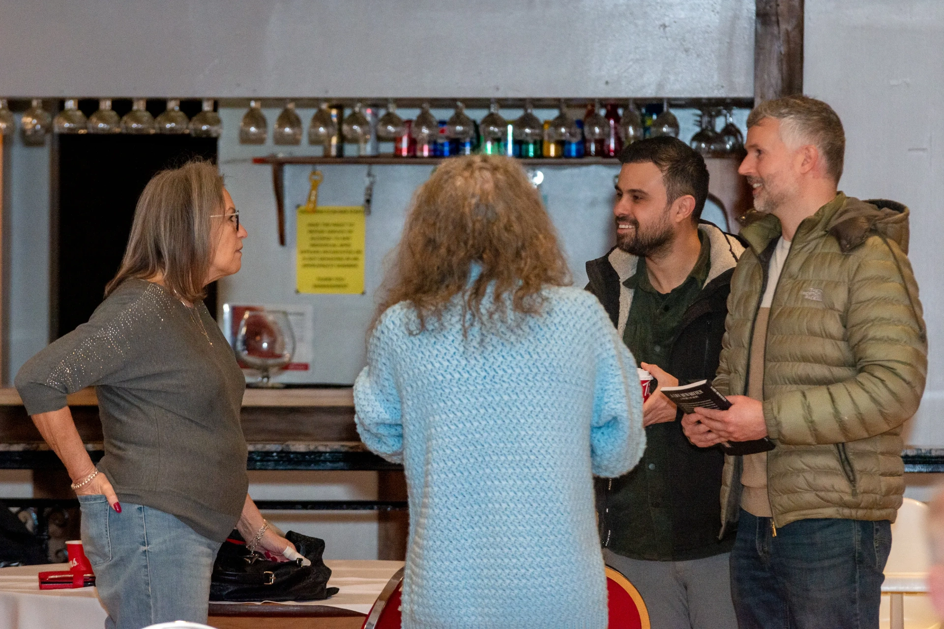 Guests chatting near the bar at the event