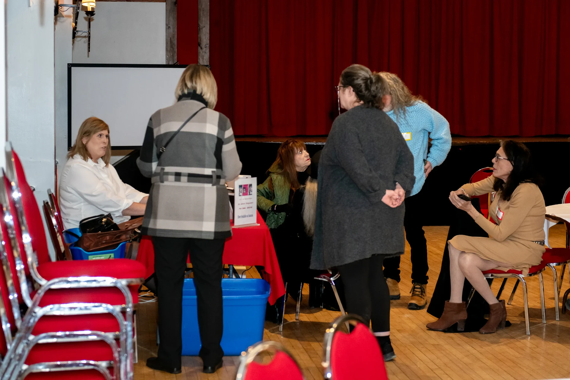 Group of guests gathered around Janet's signing table