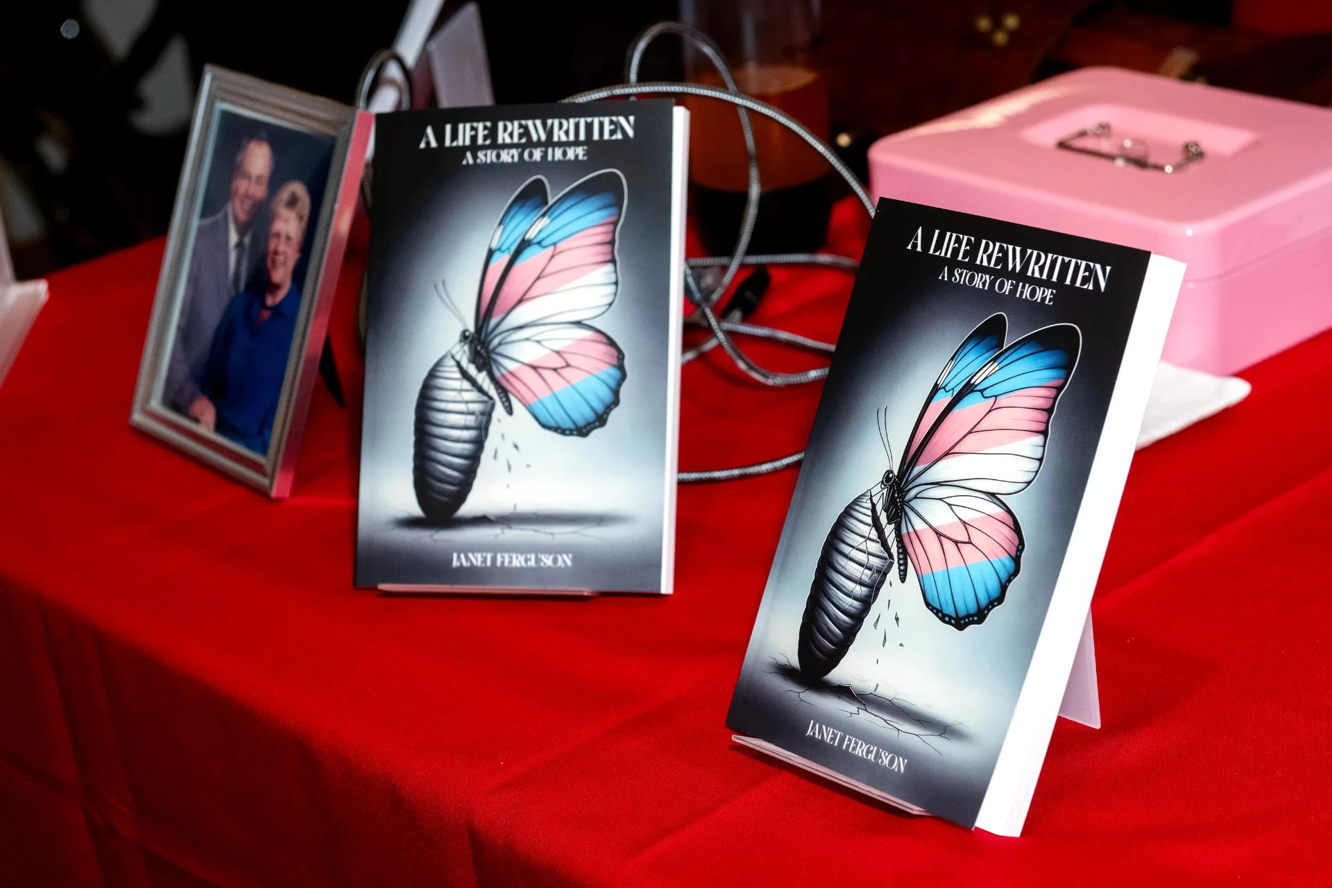 Copies of A Life Rewritten displayed on the signing table