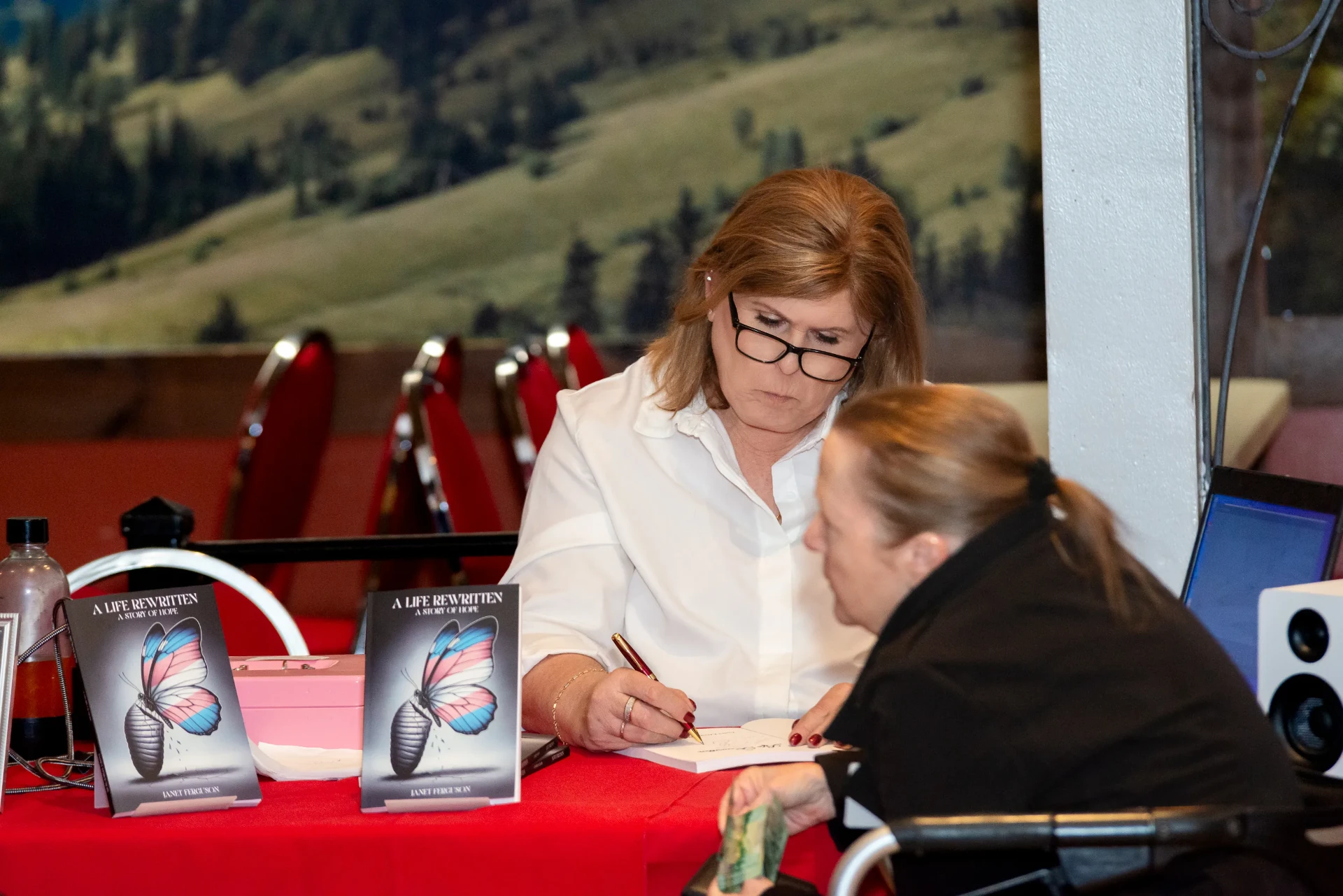 Janet personalizing a copy for a reader