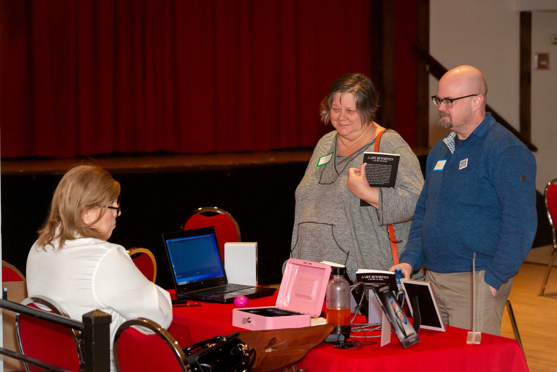 Janet chatting with two readers at her signing table